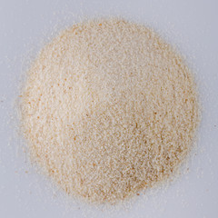 natural organic semolina on white acrylic background