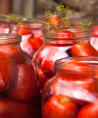 Pickling (canning) the tomatoes.