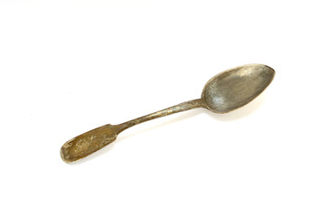 Old antique spoon on a white background. Isolated