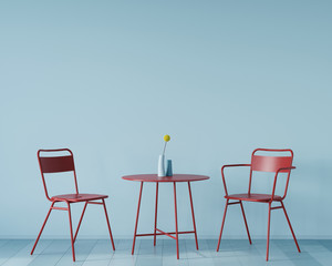 Interior with a small red table and two chairs on a background of blue wall