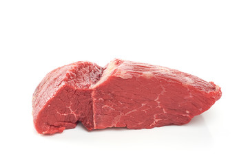 A large piece of peeled side of veal meat on a white background. A fresh piece of knuckle.