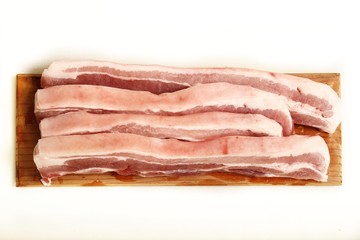 Fresh and raw sliced pork belly meat on an isolated white background