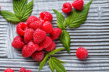 juicy fresh natural raspberries on a gray wooden rustic background