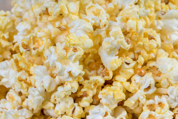 Heap of delicious popcorn, isolated on white background. Scattered salted popcorn, texture background. Top view, scattered salted popcorn texture background.