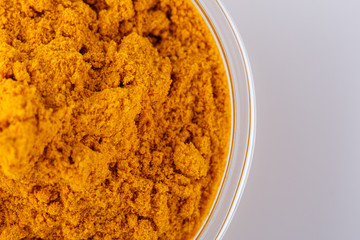 natural turmeric powder on white acrylic background