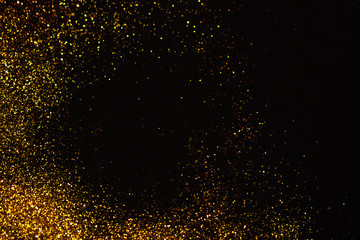 Fototapeta na wymiar Abstract holiday background, gold Stardust on black.