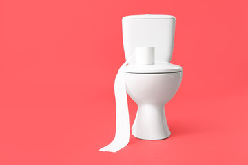 Toilet bowl with roll of paper on color background