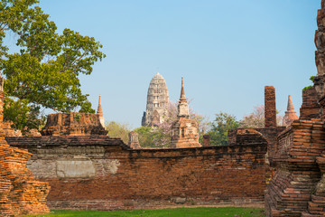 Fototapeta premium Historical and religious architecture of Thailand - ruins of old Siam capital Ayutthaya. View to brick remains of Wat Mahathat temple