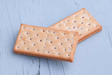 Chocolate Sandwich Cookies. Rectangular cracker with chocolate layer. Blue background
