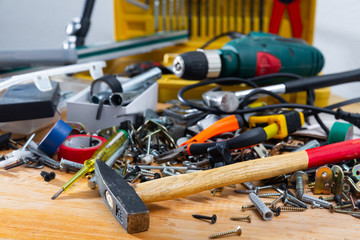 Hand tools in mess on wooden table