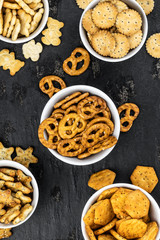 Mixed Snacks on dark background (close up shot; selective focus)