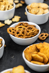 Mixed Snacks on dark background (close up shot; selective focus)