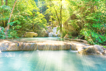 Tropical landscape with beautiful cascades of waterfall and green trees in wild jungle forest. Erawan National park, Kanchanaburi, Thailand