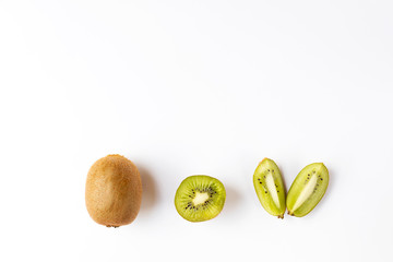 A set of fresh whole and sliced kiwis isolated on a white background. flat lay, copy space. Tropical abstract background.