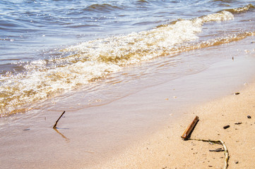 Golden sandy seashore with transparent wave