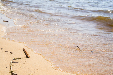 Golden sandy seashore with transparent wave