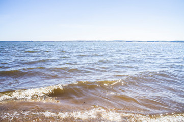 Golden sandy seashore with transparent wave