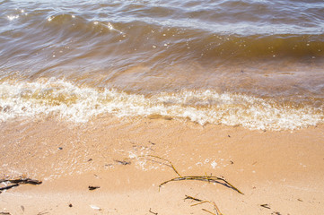 Golden sandy seashore with transparent wave