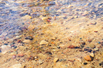 Golden mountain stream with beautiful stones and clear water