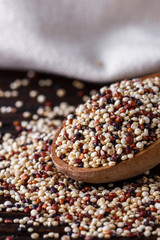 Fototapeta na wymiar mix of quinoa grains on dark wooden rustic background