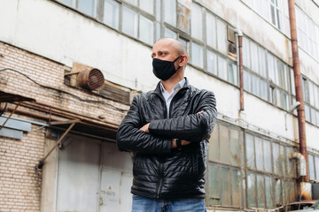 The man wears a black protective mask.The mask prevents corona virus and air pollution by dust.