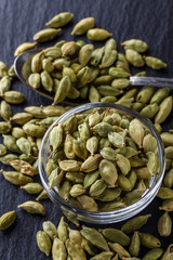 fragrant green cardamom on a dark stone background