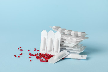Hemorrhoidal suppositories on color background
