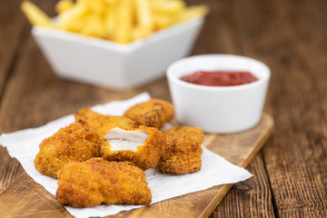 Vintage wooden table with fresh made Chicken Nuggets
