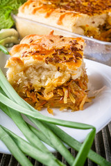 freshly baked cabbage pie on rustic wooden background