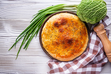 freshly baked cabbage pie on rustic wooden background