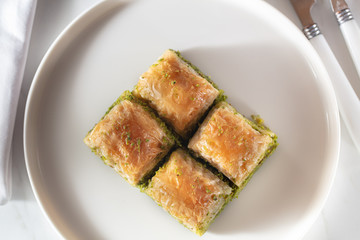 Traditional, delicious Turkish baklava on white plate