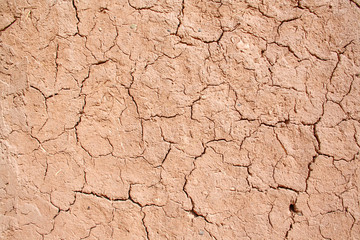 Red clay texture with cracks and straw