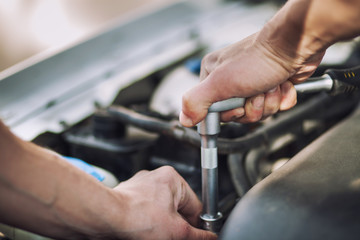 Man master repairs under the hood of the car