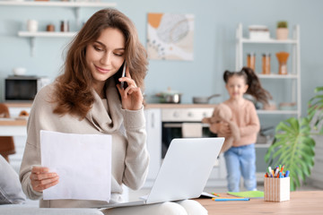 Working mother with little daughter at home