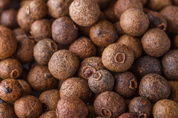 fresh spicy peppers allspice on white acrylic background