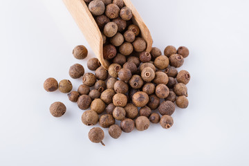 fresh spicy peppers allspice on white acrylic background