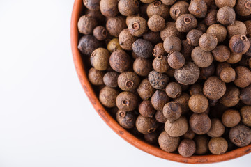 fresh spicy peppers allspice on white acrylic background