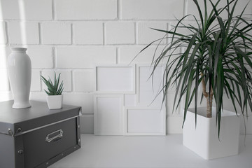 Interior. Decor for the home. Homemade flowers in white pots against a white brick wall.
