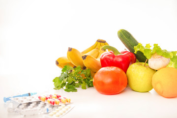 fresh fruits and vegetables, medicines on a white background,  bananas, tomato, herbs, Apple, pepper, cucumber, lemon, tablets, syringe,
