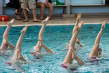 group of people jumping in pool