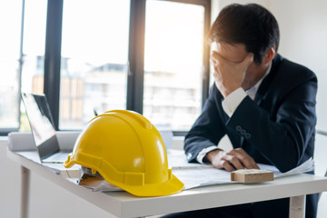 Engineer thinking and serious about fail business and construction falling down