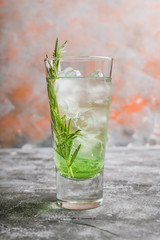 Sweet tequila based green cocktail with tarragon and rosemary. Selective focus. Shallow depth of field.