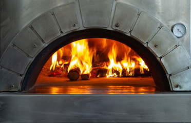 A fire is burning in a pizza oven