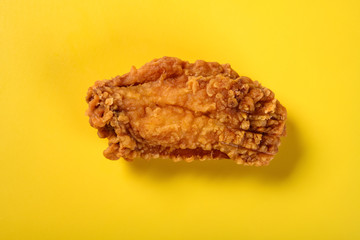 top view fresh deep fried chicken wing on yellow background