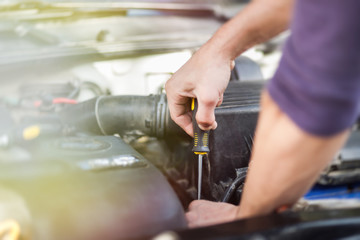 Man master repairs under the hood of the car