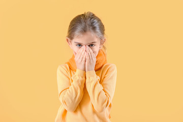 Sick little girl on color background