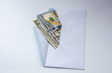  Dollars money bills spread in a white paper envelope on white background. 