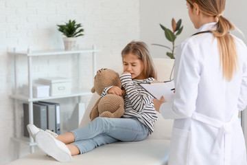 Sick little girl visiting doctor in clinic