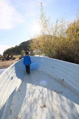 Child boating on the lake, on a beautiful autumn day