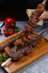 various kebabs on a gray stone background